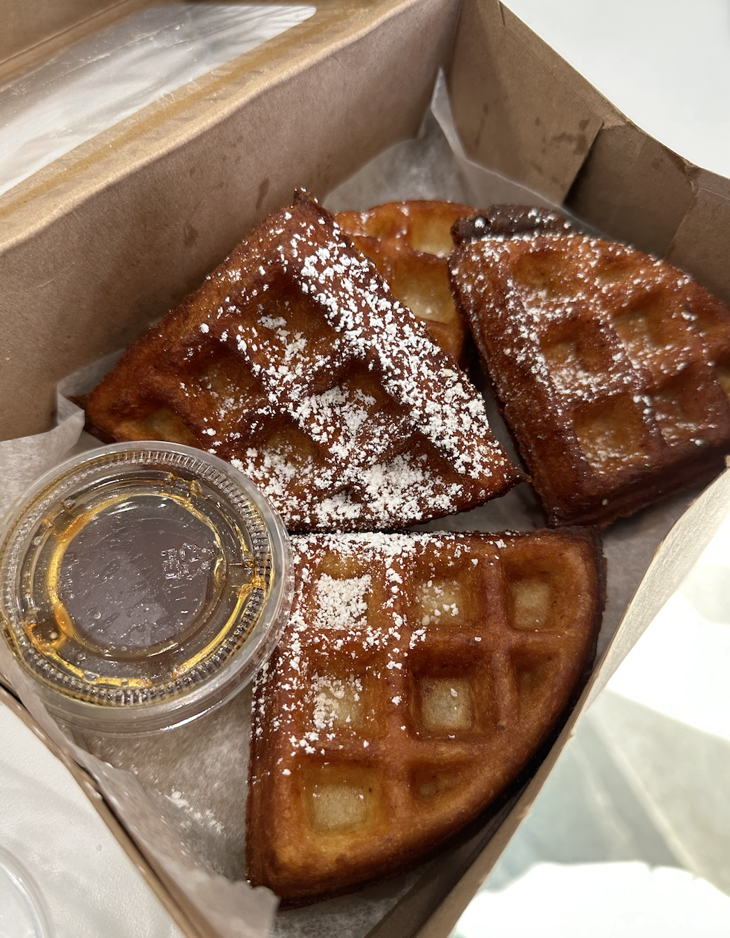  The waffle taste like a funnel cake! I was suprised. They also sell itt frozen so you can make one at home. We also had the vegan breakfast sandwich. I rather the waffle than the fake egg. Although it taste fine I kept thinking what is this.  