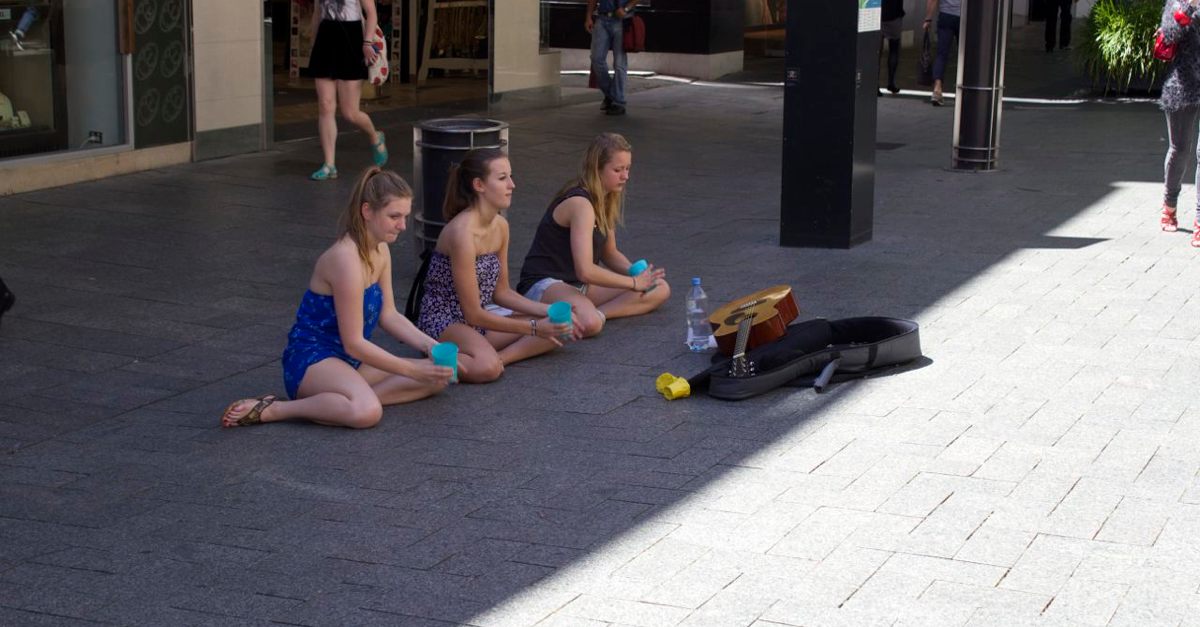 Busking with cups.