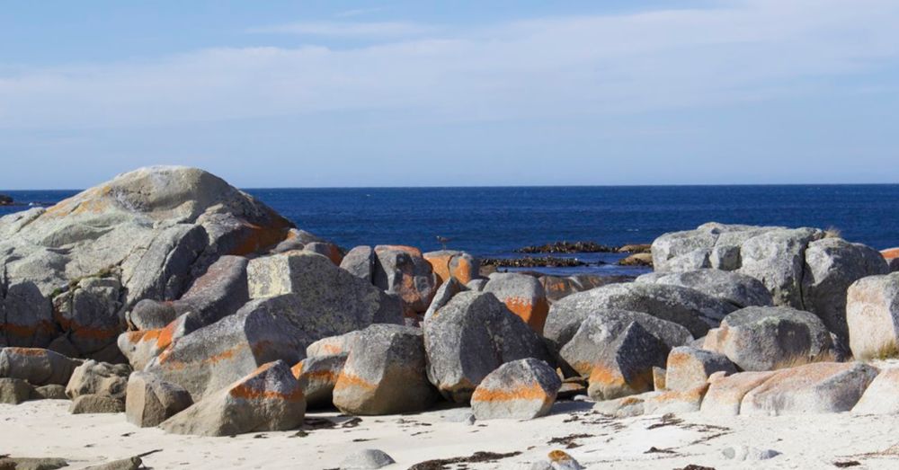 Blue Ocean, White Sand, Orange Rocks