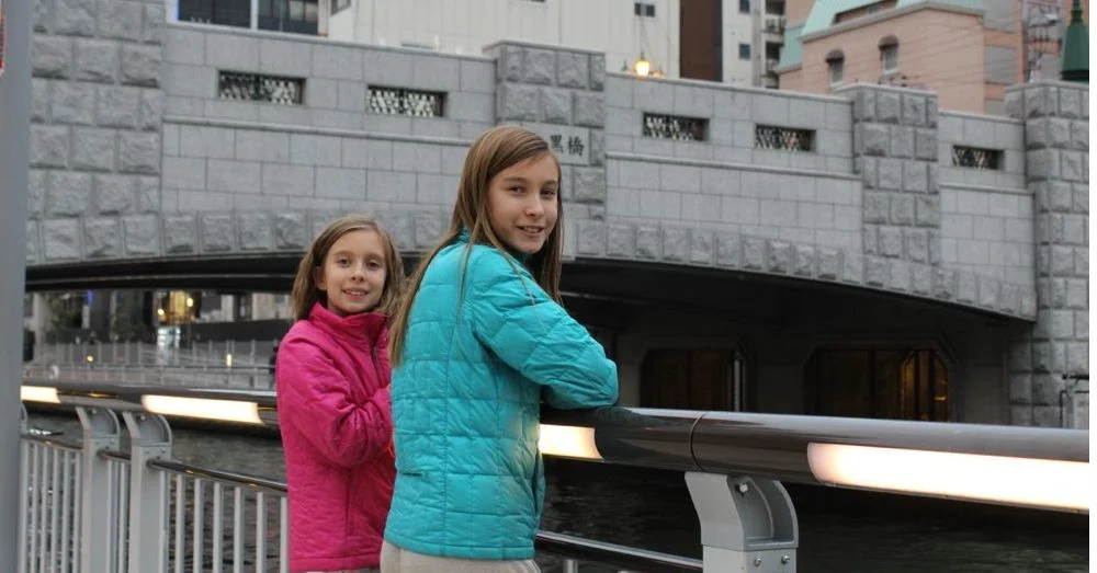Girls on a bridge.