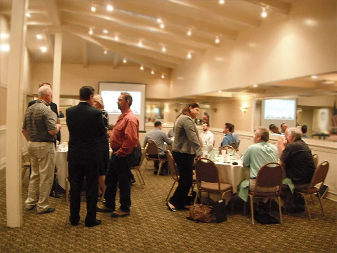 Attendees mingling prior to the start of the Quarterly Meeting.