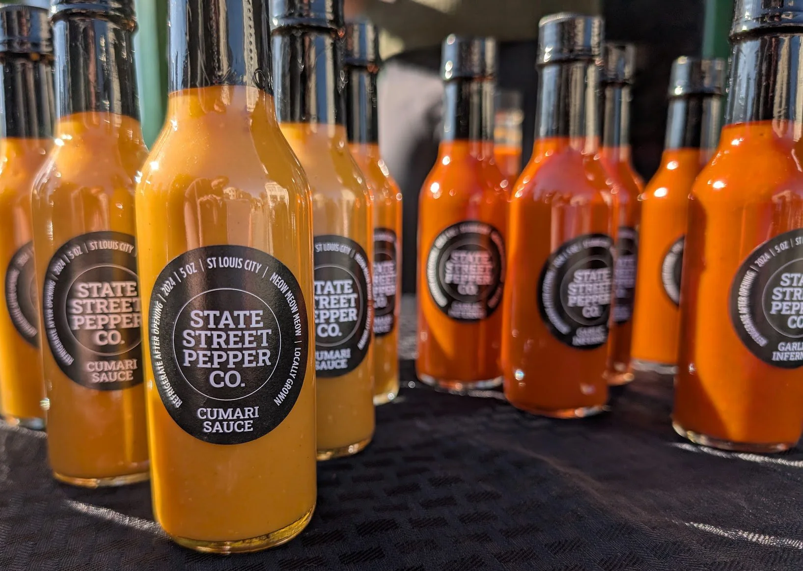 State Street Pepper bottles outside on table