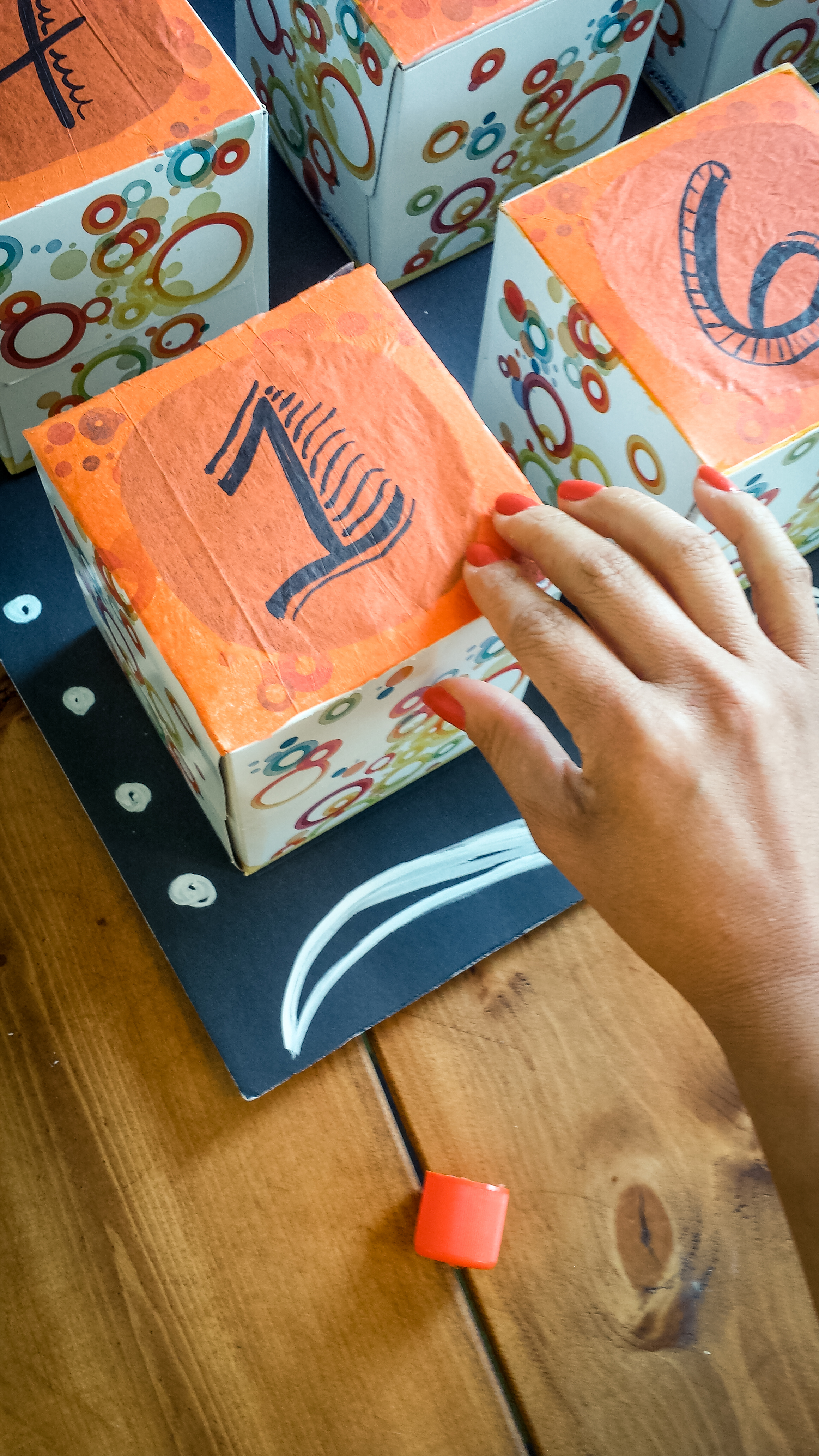 Take a tissue paper, place it on top of the box and press down around the edges making sure is tight.