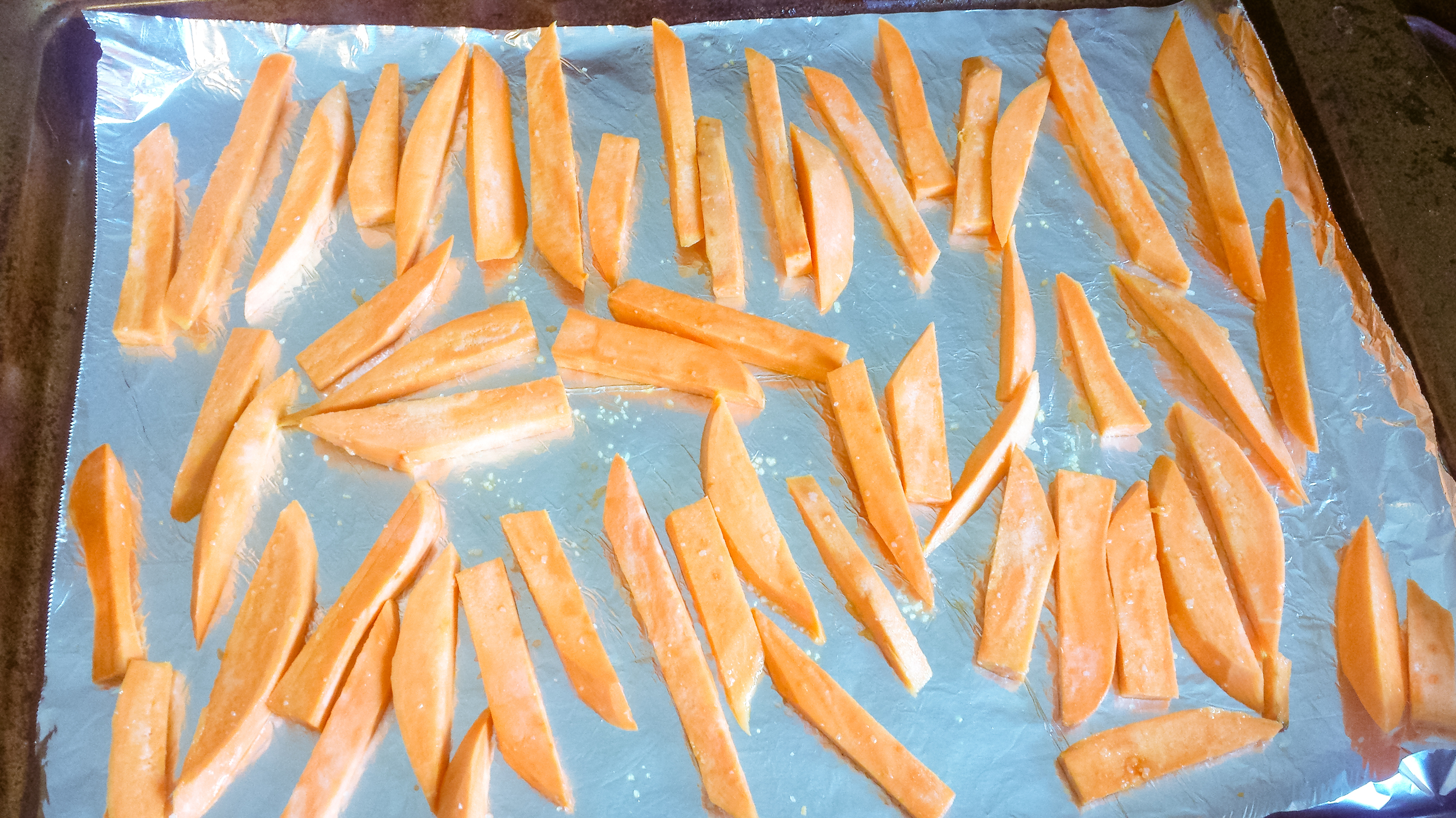 Cut your sweet potato, add oil and spices and bake