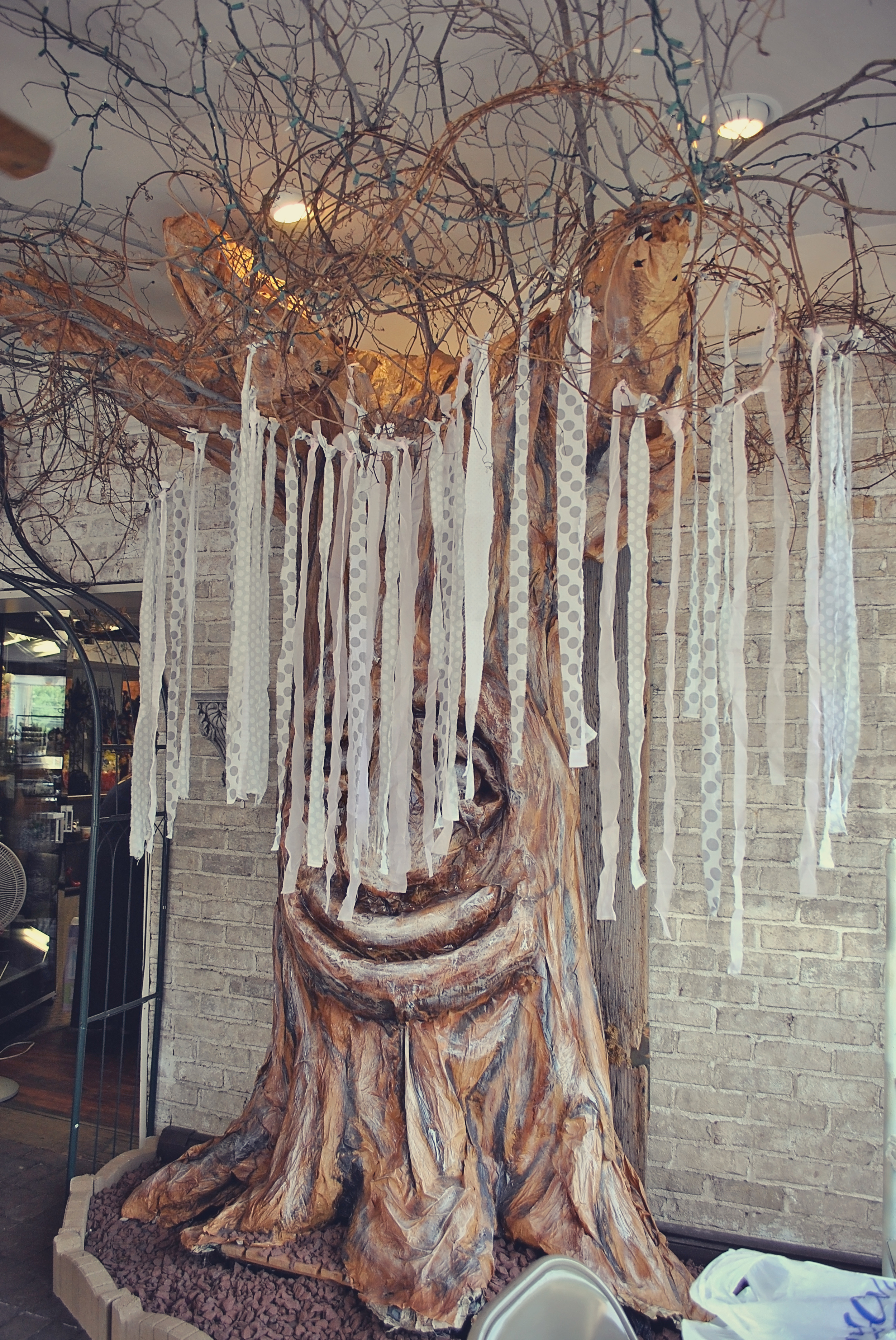 Worked with what you have- the place where we held the shower had this big tree. I wanted to the happy face tree a bit so it wouldn't look so out of place. Solution? I had fabric strips left over from the garland I had made and so, I decided to add the strips to it. It worked great and tied it into the rest of the theme.