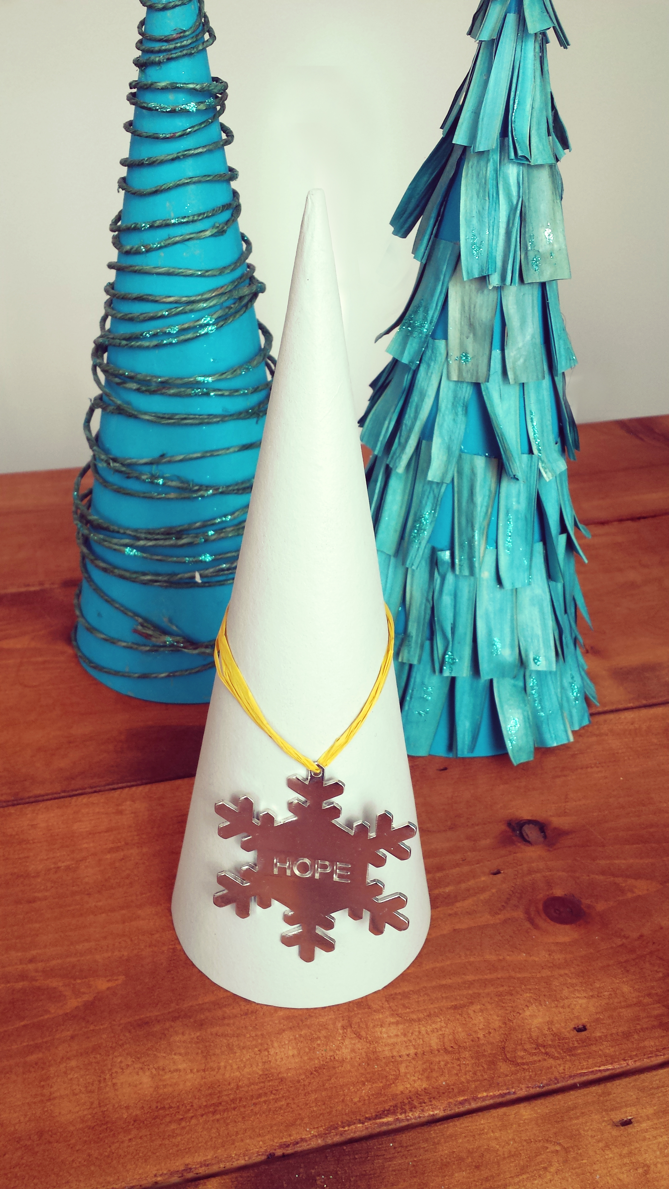 This is by far the easiest tree you'll make. All I did was use some of that gray leftover paint I had and painted the cone. Once it was dry I simply too an ornament that was given to me a couple of years ago and use some of the Raffia to hang it on the cone. That is it! The one thing to remember is to use a flat ornament. Of course you can use whatever color paint you want and whatever ornament you want. You can also use any type of string you desire to hang on the tree. Simple! Love it!