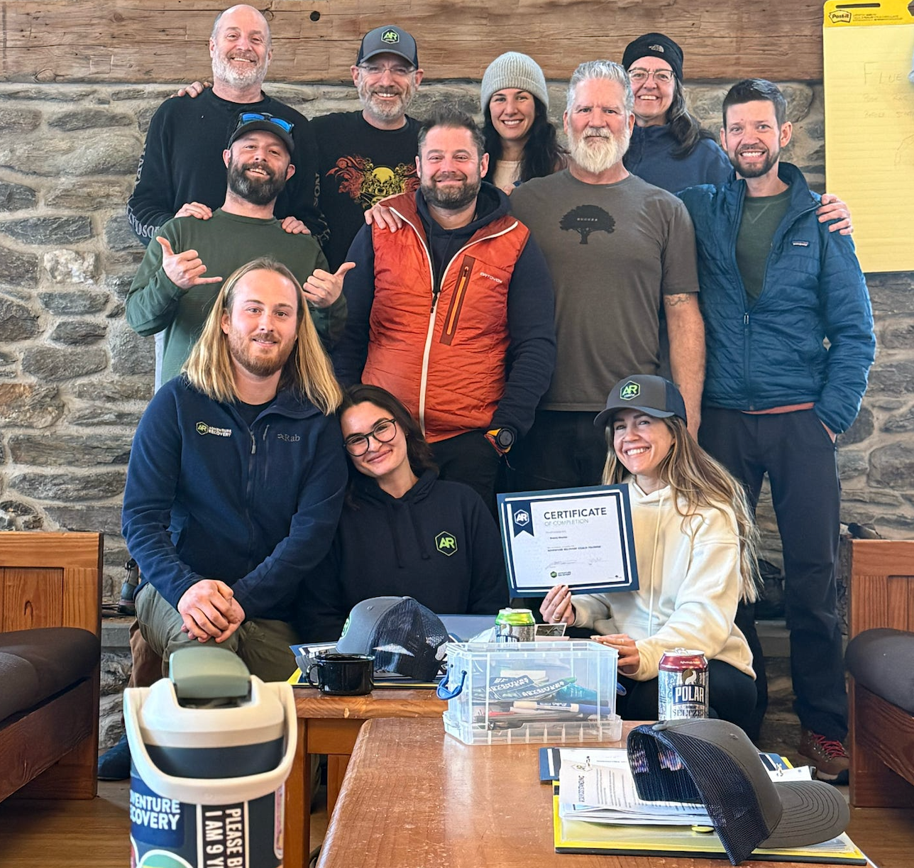 Adventure Recovery Coach Training graduates, holding a certificate of completion, smiling