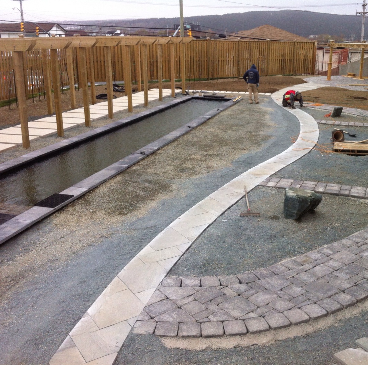 Blue Ice sandstone wave inlay into Citadel Black sanstone and winsor stone pavers.jpg