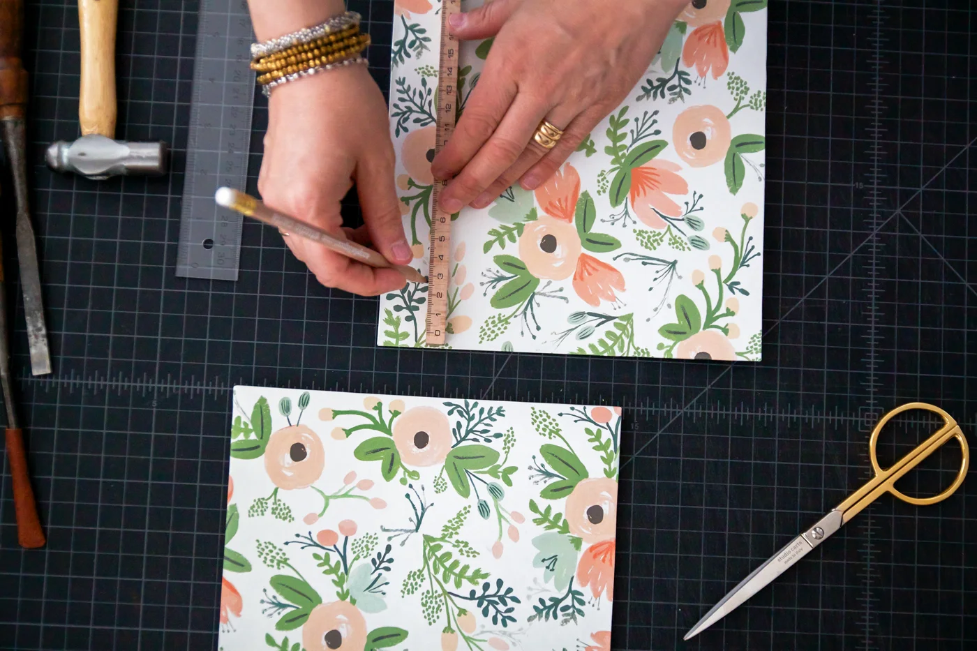 Step 7: On each cover, create 4 slits for your ribbons. First measure the width of your ribbon. Then starting about 1 1/2 inches or 4 centimeters from the top (short side), and about 1 inch or 2.5 centimeters from the edge (long side), make a mark, length-wise, that measures the width of your ribbon. Repeat at all four corners of each cover.