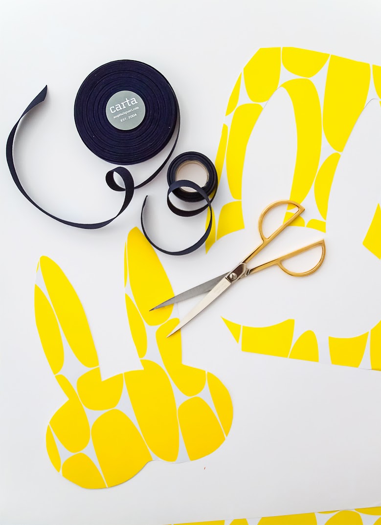 Step 2: Choose a paper for the underlying layer of your mask. (We used selects from their Blue, Orange and Yellow Collection .) Place your cardboard cutout onto the back to this paper. Trace and cut.