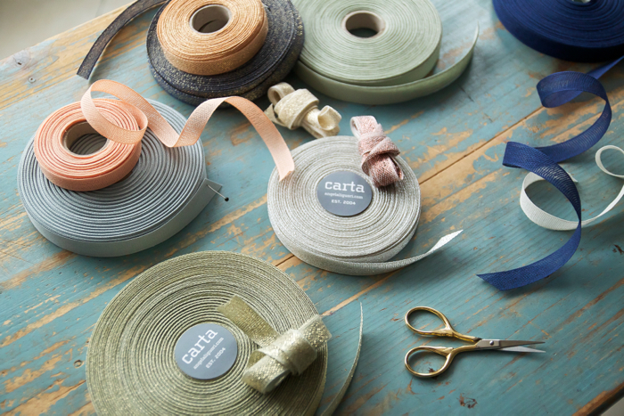 Supplies: With a wedding or shower in mind, we choose a pastel assortment of Studio Carta wide loose and tight weave ribbon in natural cotton and wide metallic loose weave. Of course, by using different ribbons and flowers, this garland can be adapted to fit any palette.