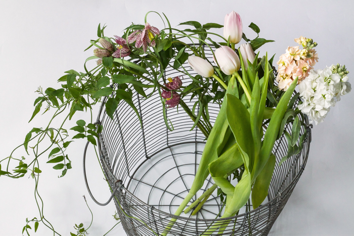 Supplies 2: For this garland you want some type of vine, plus long-stemmed flowers of your choice. As this loosely structured garland does not use any florist foam, be sure to pick blooms that won’t immediately wilt. We opted for winding jasmine vines, bell-like fritillaria, pink tulips and a cluster flower we found at Trader Joes. Tip: The length of your garland will determine how many blooms you need. Other supplies include thick twine, scissors and something to with which to secure the flowers to the twine. We used Studio Carta’s soon-to-be released gold embroidery thread (below), because we liked the suble shine. You could also use floral wire.