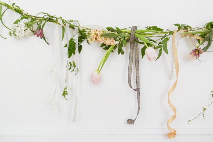 Above: A section of our finished garland draped in a simple arch on a white wall at Studio Carta. You could also hang it from the ceiling or, for a centerpiece, lay it down the length of a table.