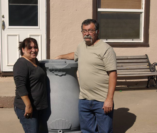 Pictured: Mr. & Mrs. Martinez with their rain barrel.