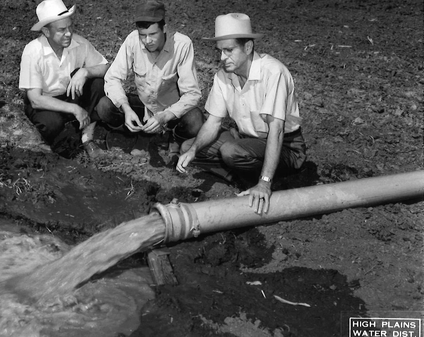 HPWD Geologist William L. (Bill) Broadhurst (at right) is shown at a well site in this HPWD file photo. The other men are unidentified.
