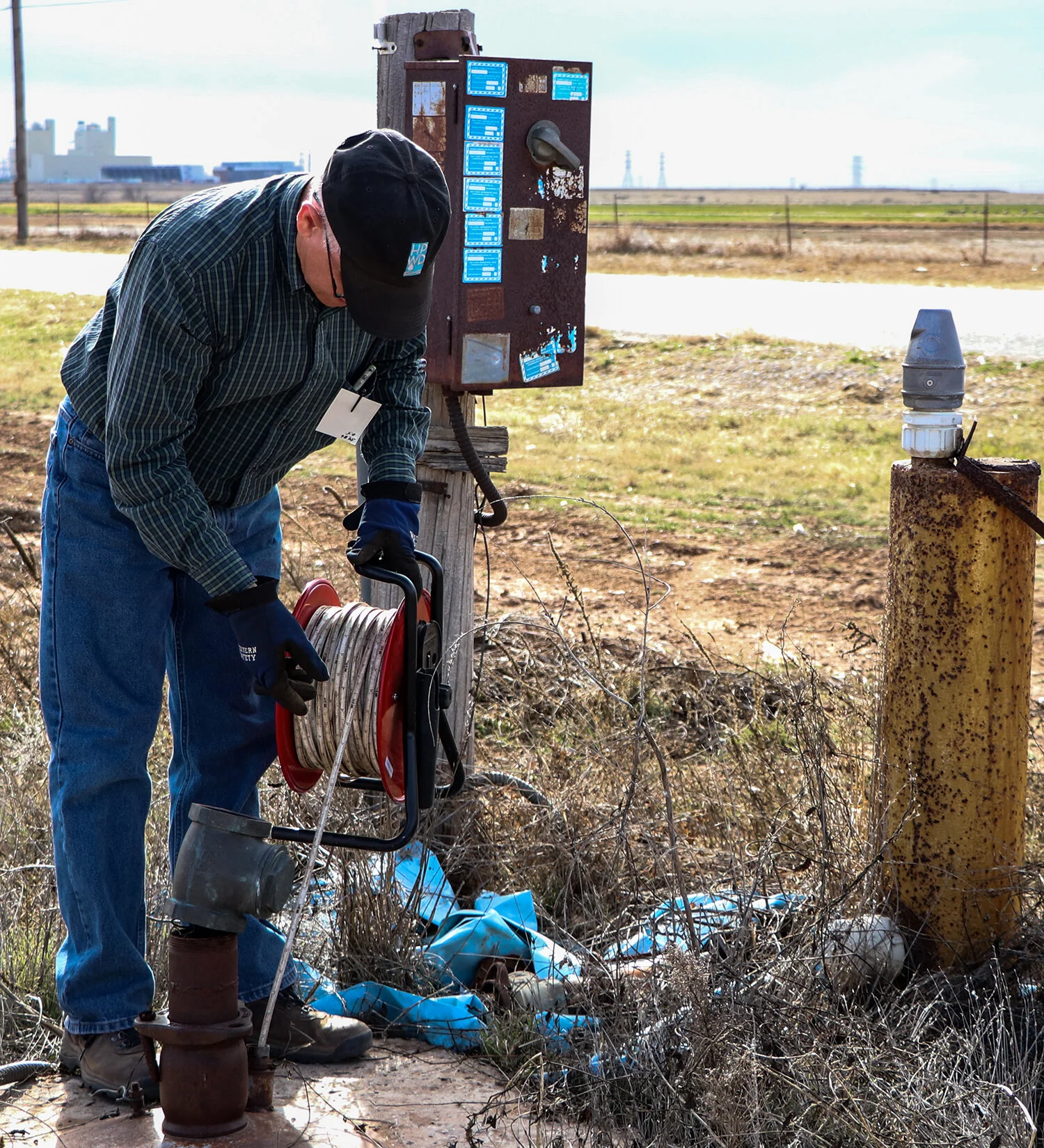 FIELD STAFF SUPERVISOR KEITH whitWORTH MAKES A WATER LEVEL MEASUREMENT IN A PRIVATELY-OWNED OBSERVATION WELL WITHIN THE DISTRICT.