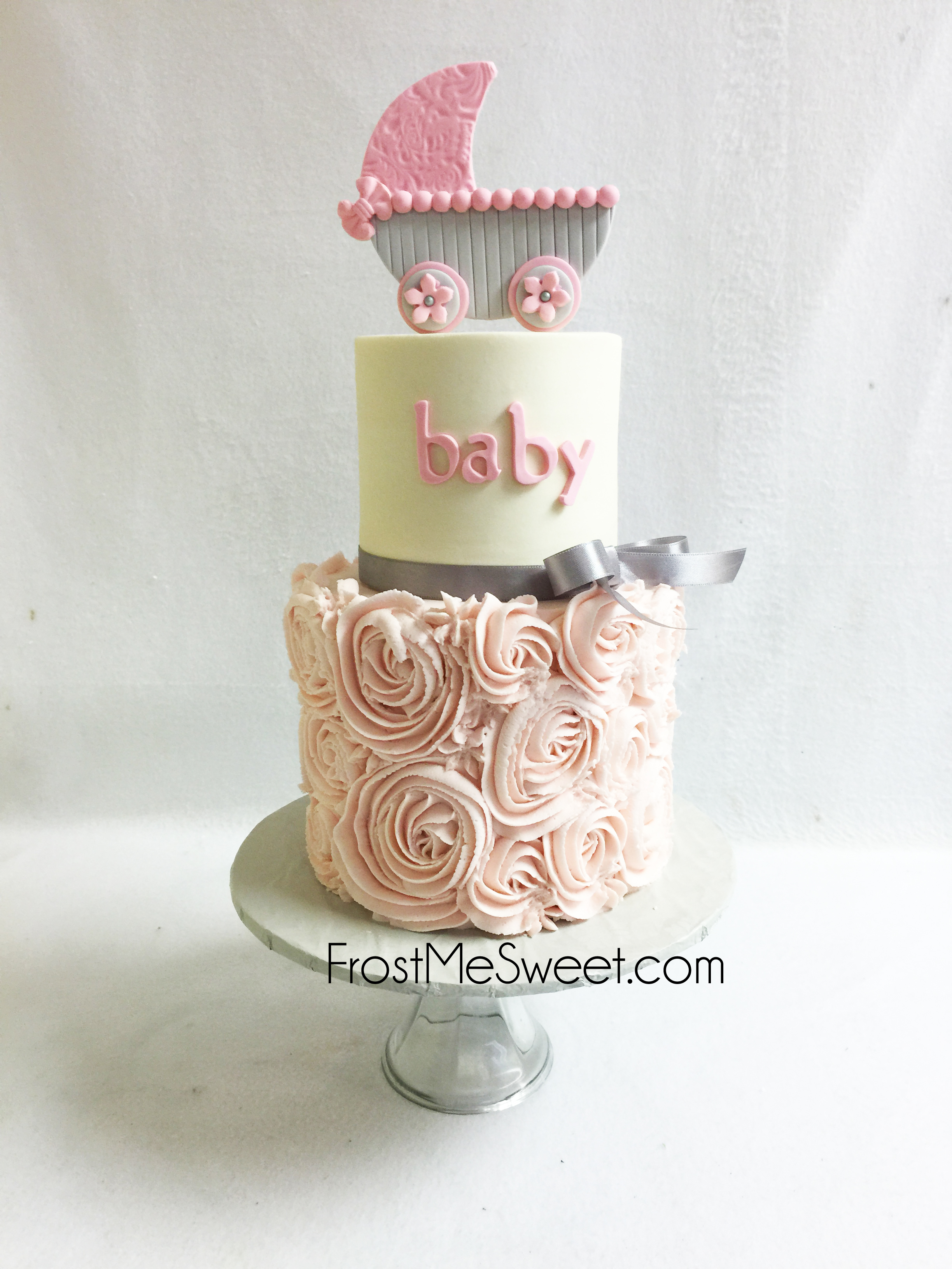Pretty Pink and grey baby shower cake with Rosettes