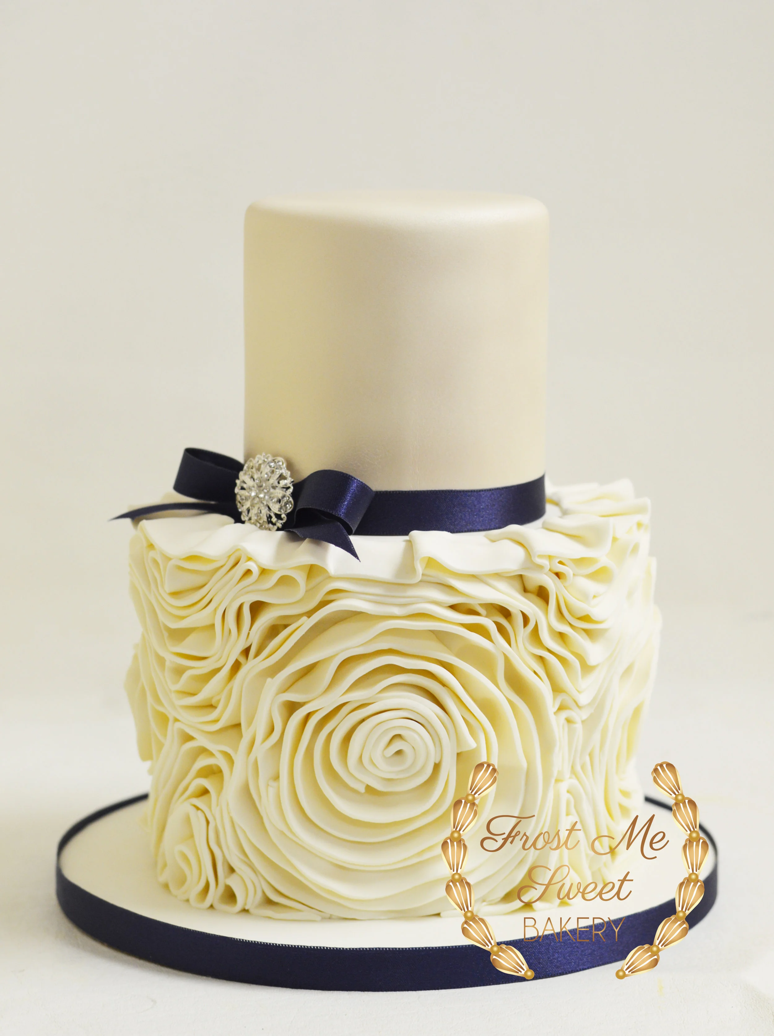 ivory shimmer with fondant rosette and navy ribbon.jpg