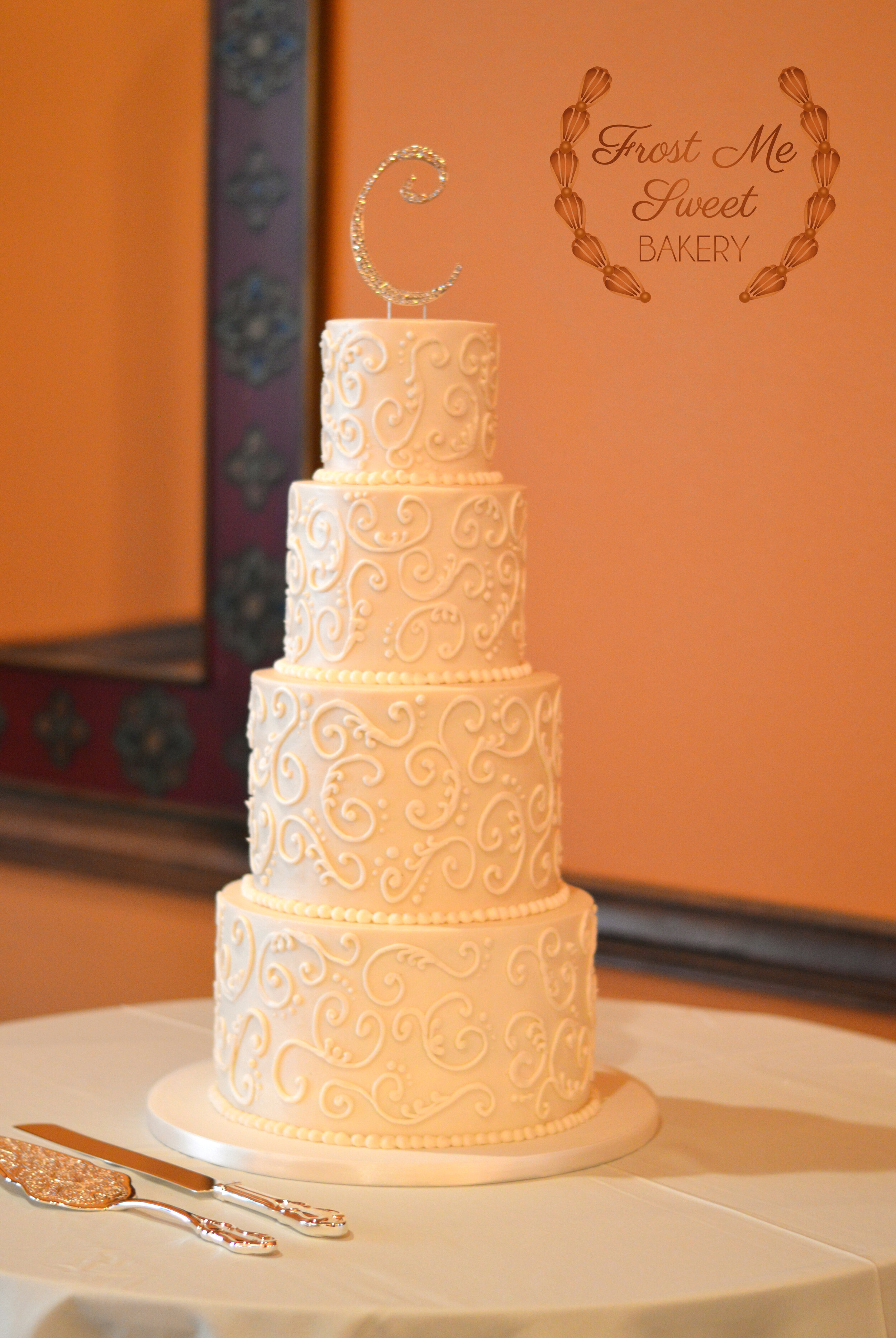 White scrolling wedding cake