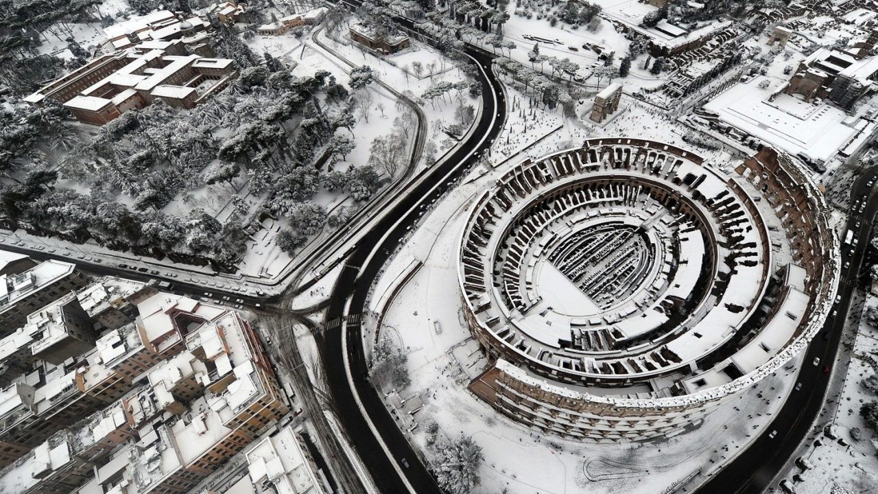 Roman Colosseum, Italy Now here's a scene you don't see every day—the Colosseum from above while under a blanket of snow. ( via )