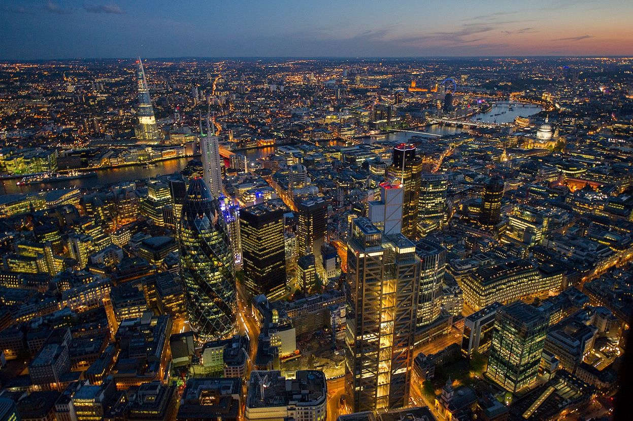 London, England (The City) London's financial district is all aglow, featuring "the Gherkin" building. ( via )
