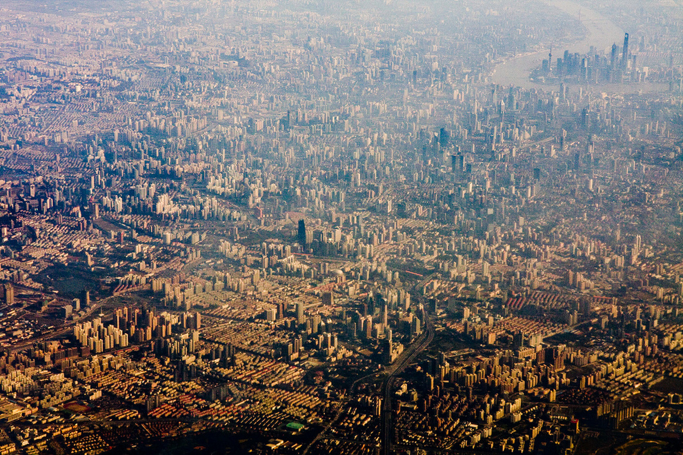 Shanghai, China Shanghai is the world’s largest city proper with 24 million people. You can see why. Another note: Though this picture looks a bit old, you’ll notice the Shanghai World Financial Center among the towers in the Pudong skyline (it looks like a can opener). This means the picture was taken no earlier than 2008. The picture looks old because of smog. ( via )