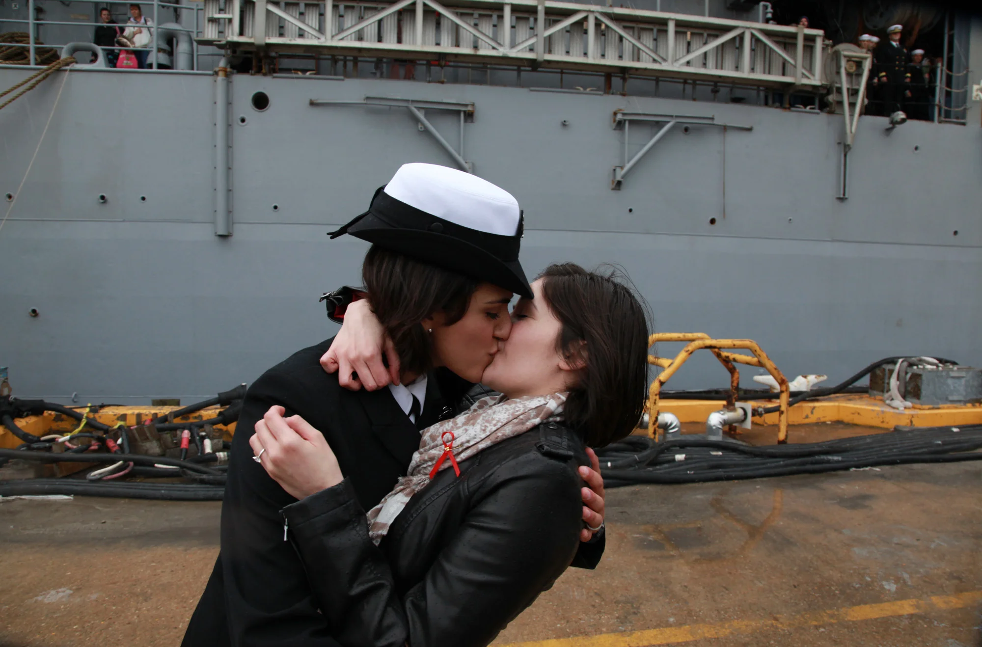 Two female sailors kiss as the Navy tradition of "first kiss" catches up with repeal of the "don't ask, don't tell" policy that previously barred openly gay men and women from serving in the U.S. military.