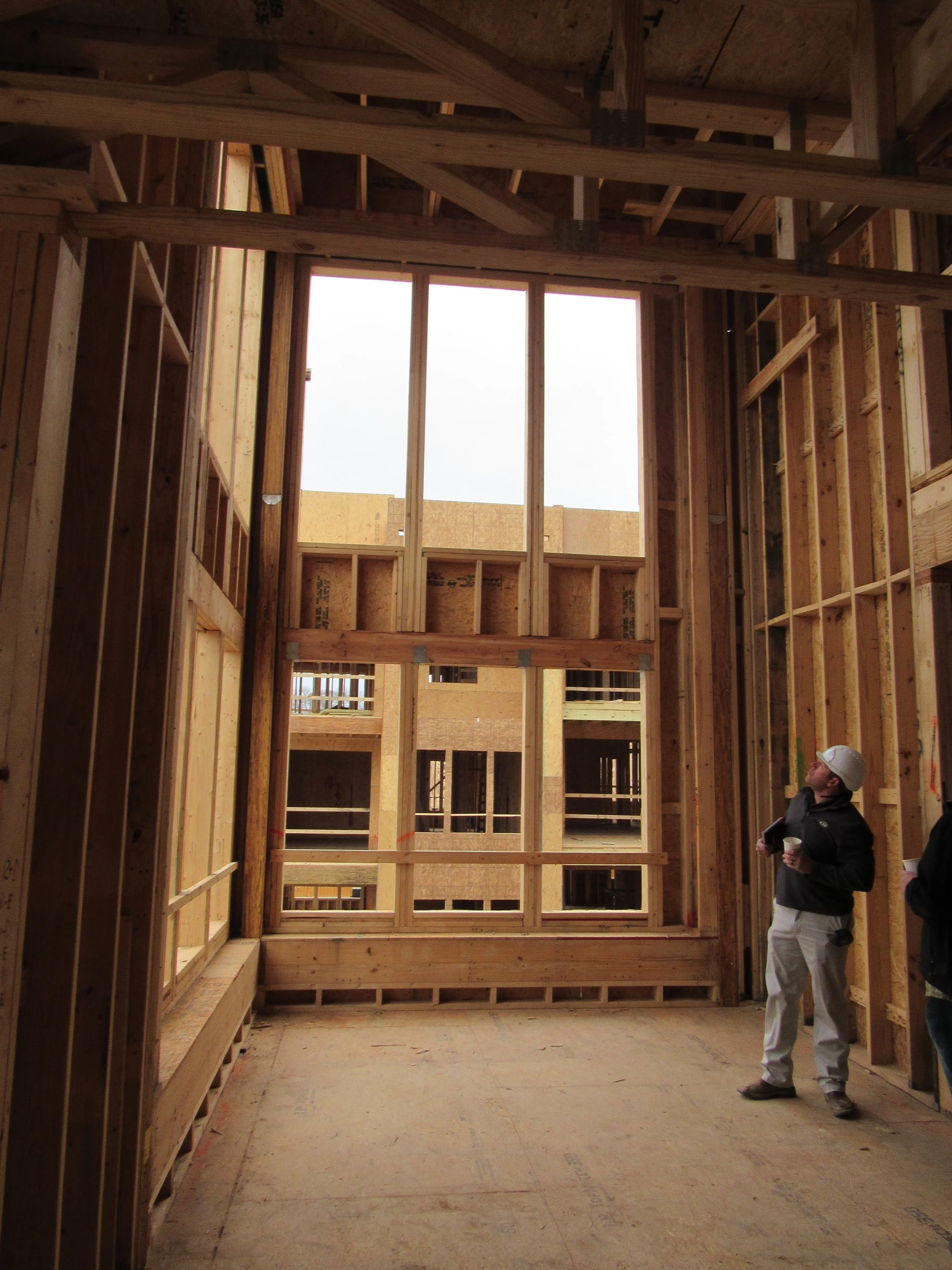  double height living space at corner bump out, view from entry, mid-construction 