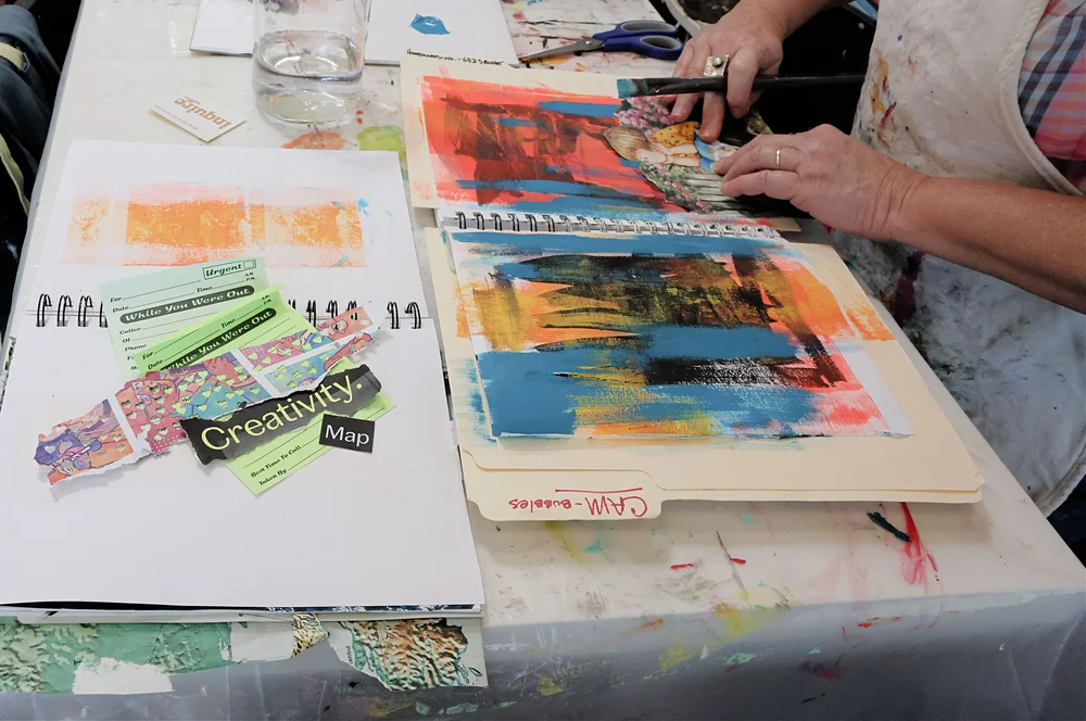 Two sets of hands making art together at The Haven