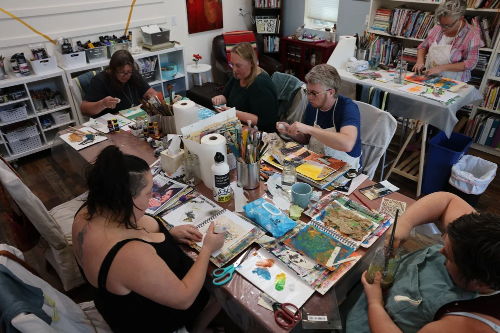 A small group working side by side at The Haven