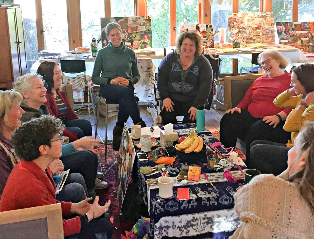 A circle of women laughing together at an Unfold Art retreat