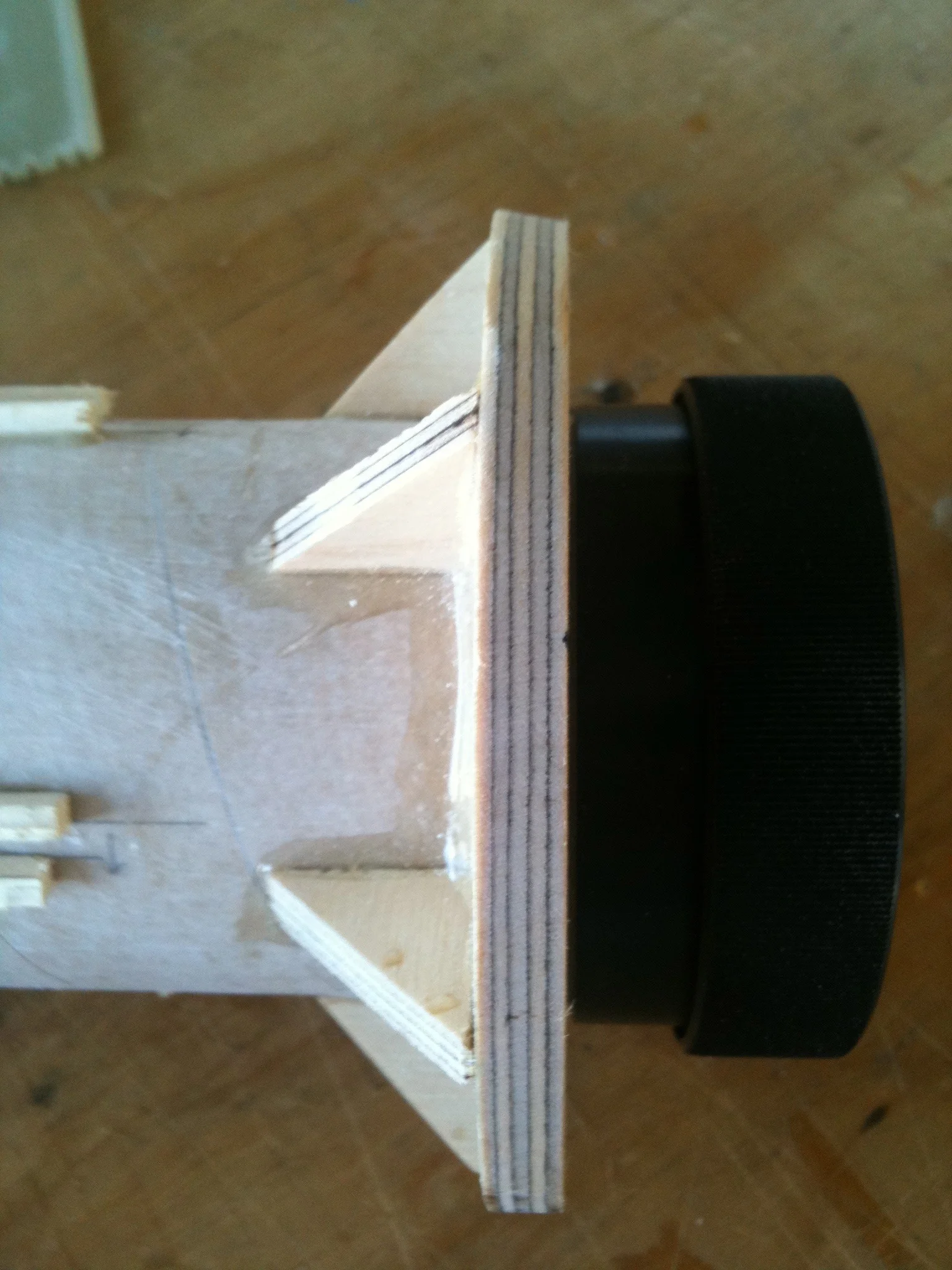 Small plywood wedges brace the area where the thrust from the rocket motor is applied. 
