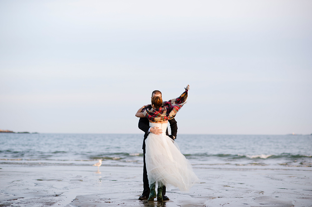 Bride and groom dancing on the beach