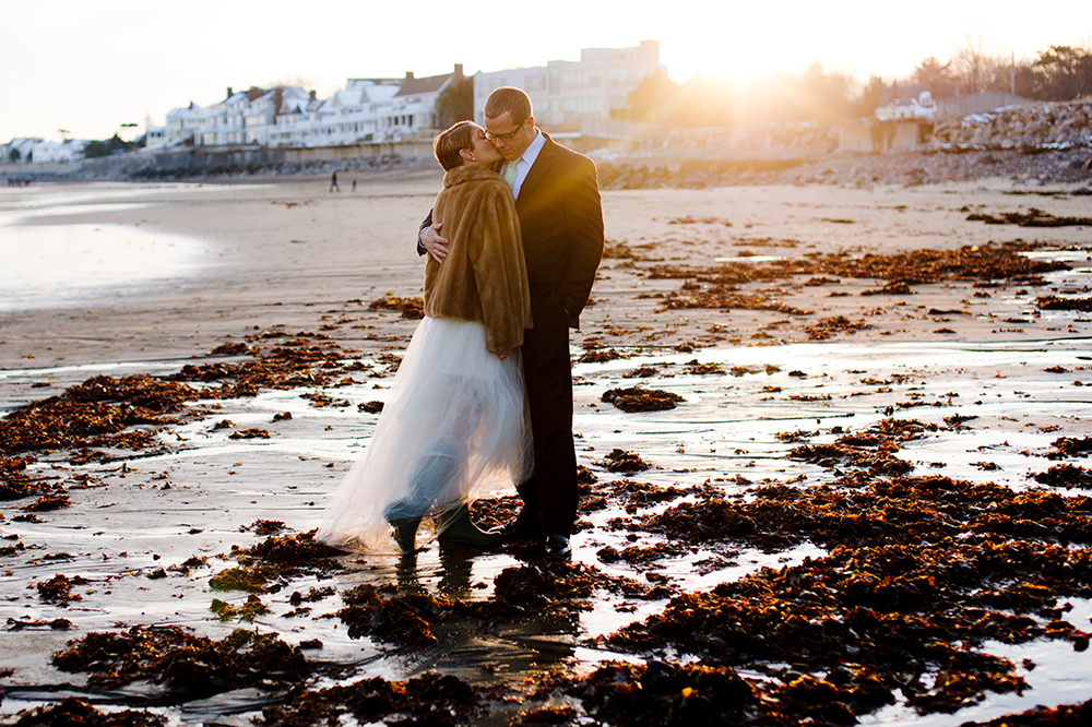 Bride kisses groom on the beach