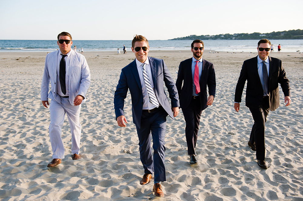 Groomsmen walking on the beach at the Newport Beach house