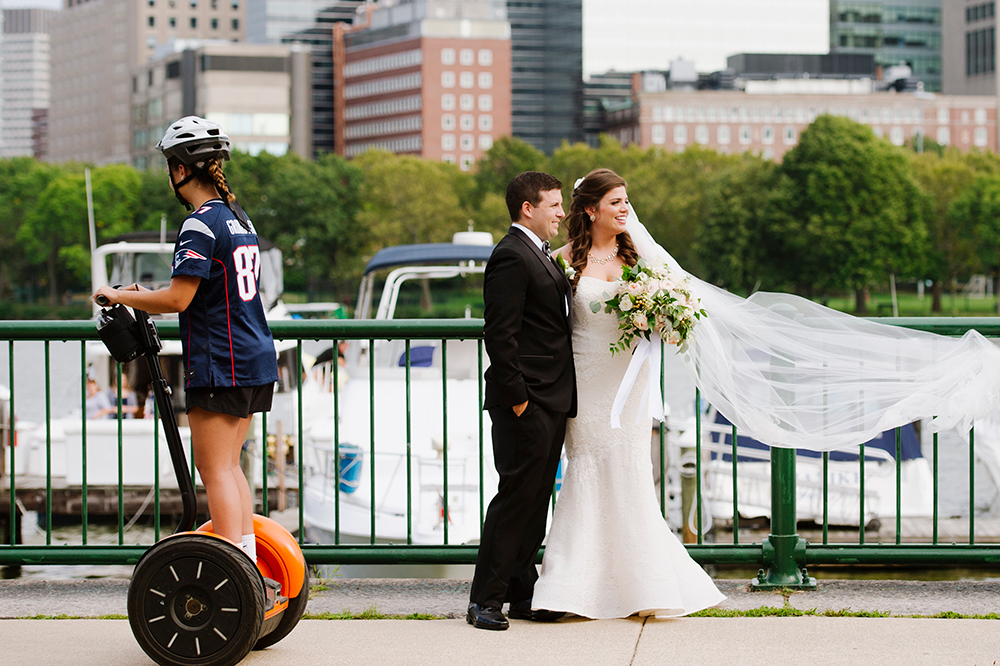 Bride and groom pose for photo along the Boston Esplanade