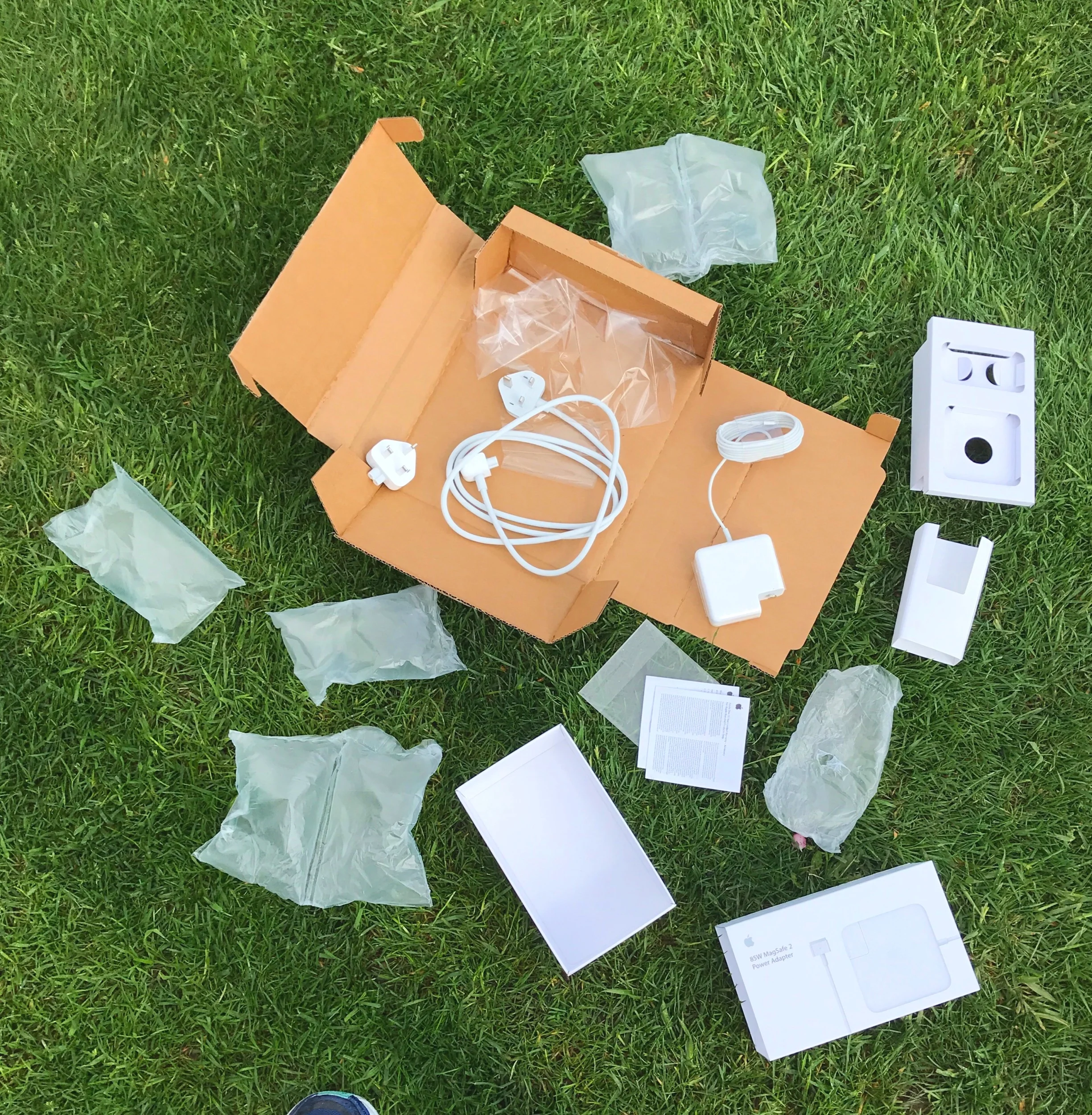 All the packaging. Set against synthetic looking grass. I have to remind myself that everything we have and consumer comes from the earth.