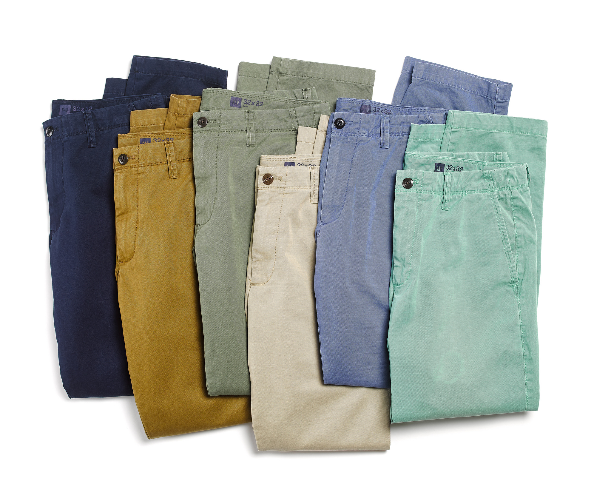 Assorted colored chinos and pants folded and stacked flat lay.jpg