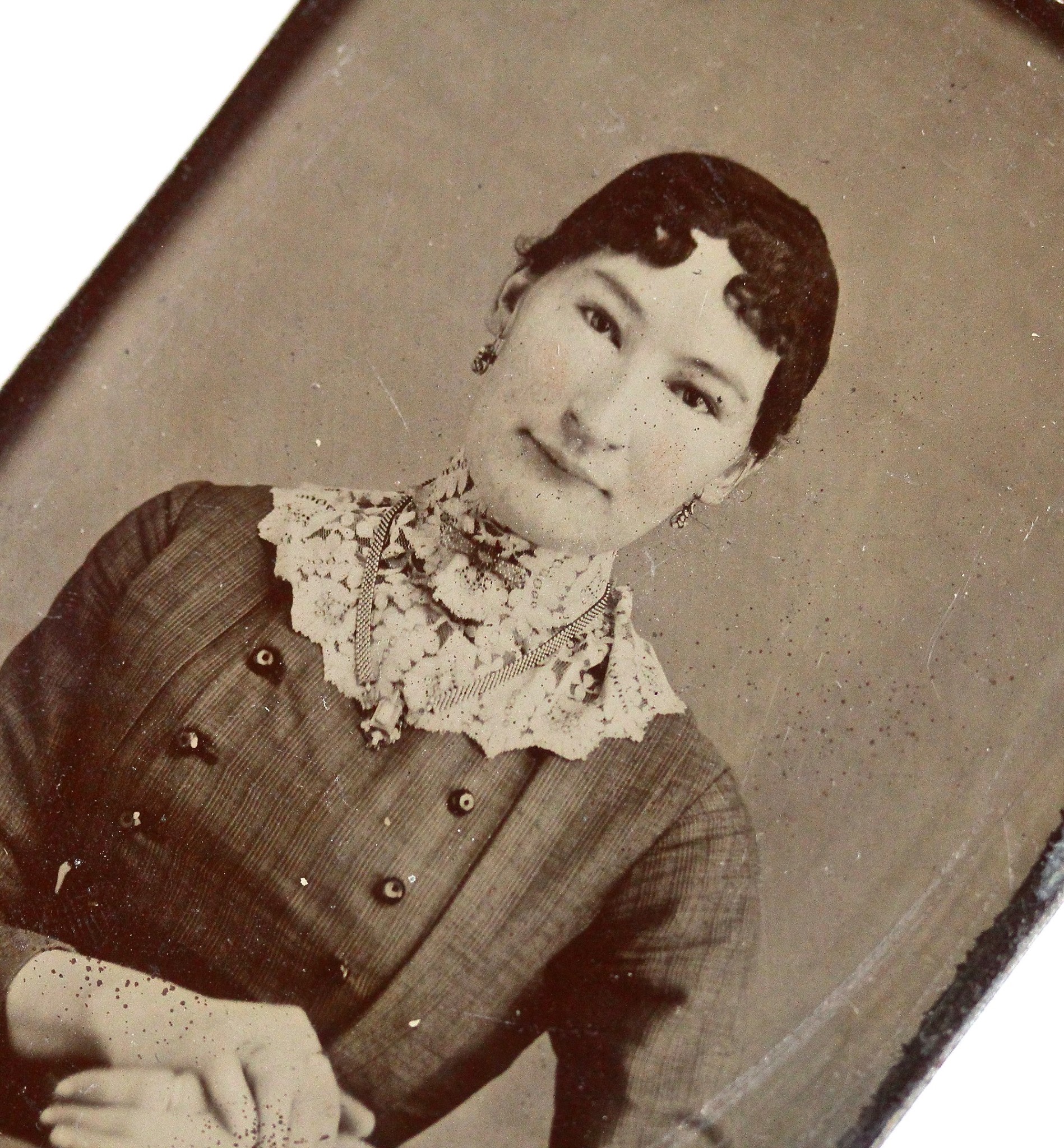 Victorian era tintype of an exotically alluring woman wearing a substantial book chain and dainty drop earrings.