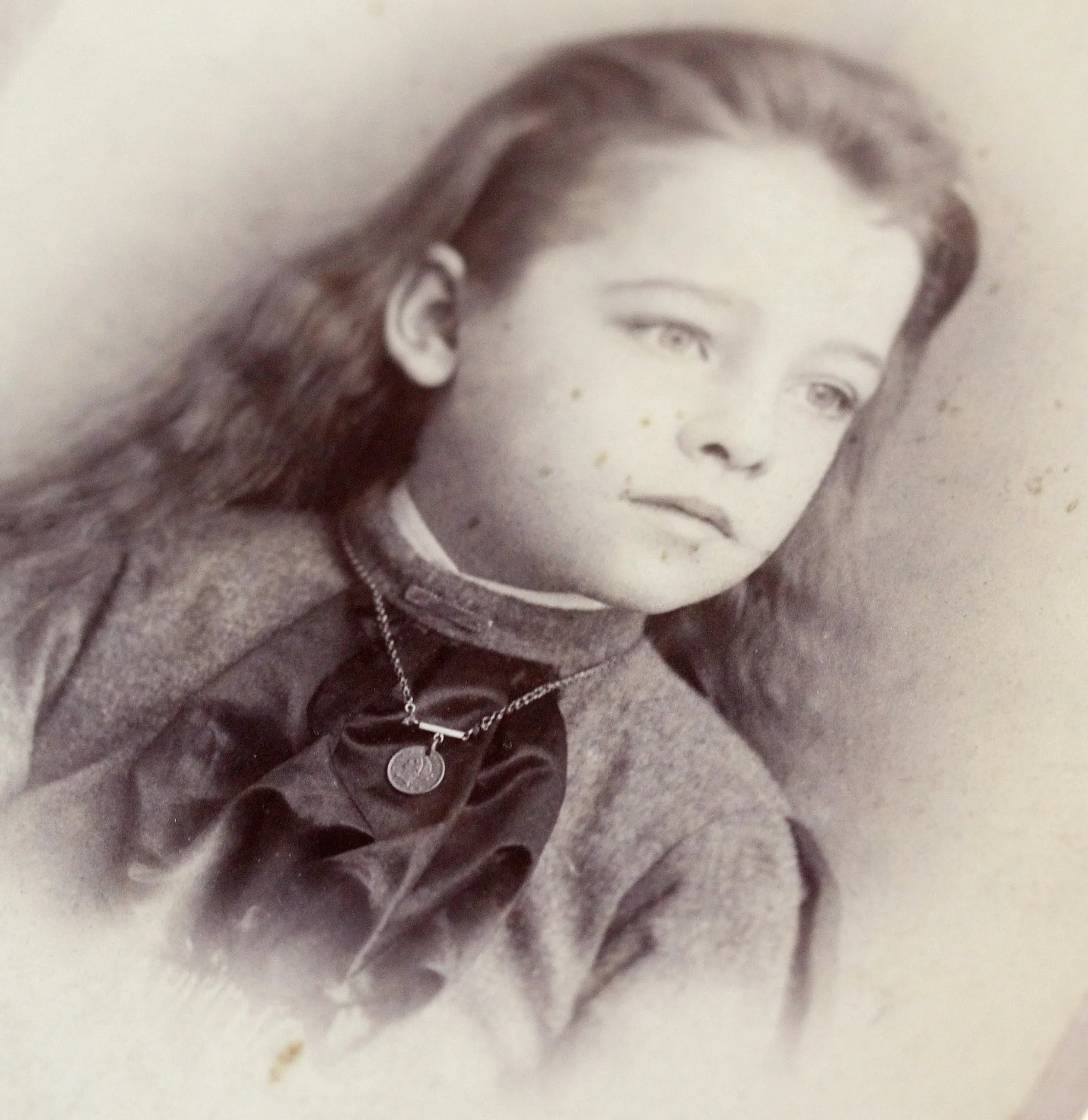Victorian era cabinet card from Birmingham, Connecticut, featuring a vignette of an usually attractive androgynous young child wearing a love token charm necklace. (This is one of my favorite pictures from my personal collection!)