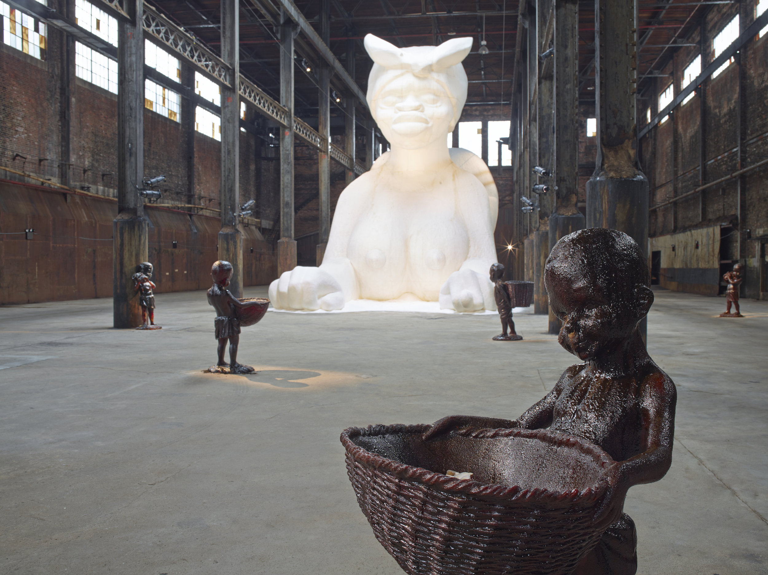  Kara Walker,  At the behest of Creative Time Kara E. Walker has confected: A Subtlety, or the Marvelous Sugar Baby, an Homage to the unpaid and overworked Artisans who have refined our Sweet tastes from the cane fields to the Kitchens of the New Wor