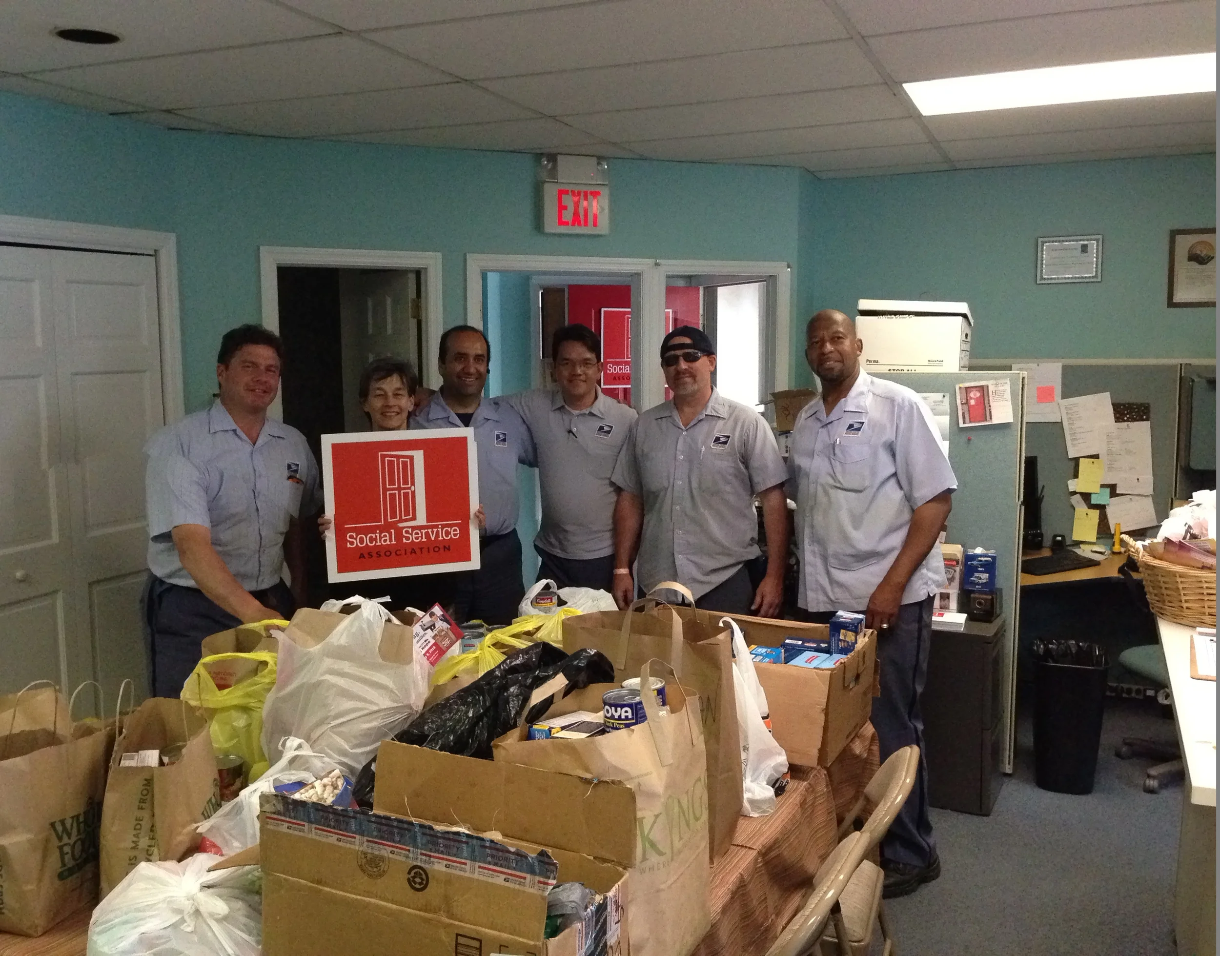 Postal workers from the Ridgewood Post Office with Board Member Judy Saydah.