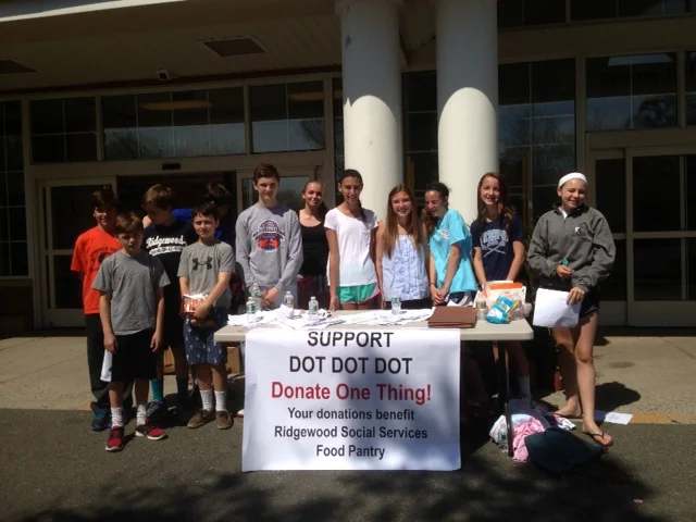 This is a photo of the DOT DOT DOT (donate one thing) food drive that took place last week at the A&P in Midland Park to benefit Ridgewood Social Services. Founded by high school student Jack Trevisan, DOT DOT DOT volunteers included seventh graders from George Washington middle school. The day was a huge success!
