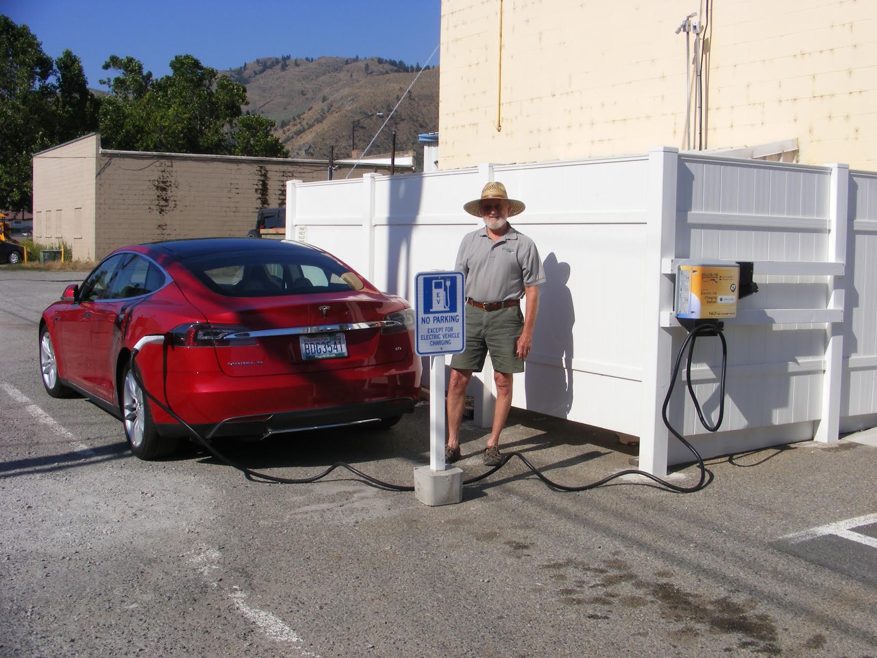 Randy Brooks, Charging Network Coordinator with Plug-in NCW, charging his Tesla using the new EV Charger in Oroville.