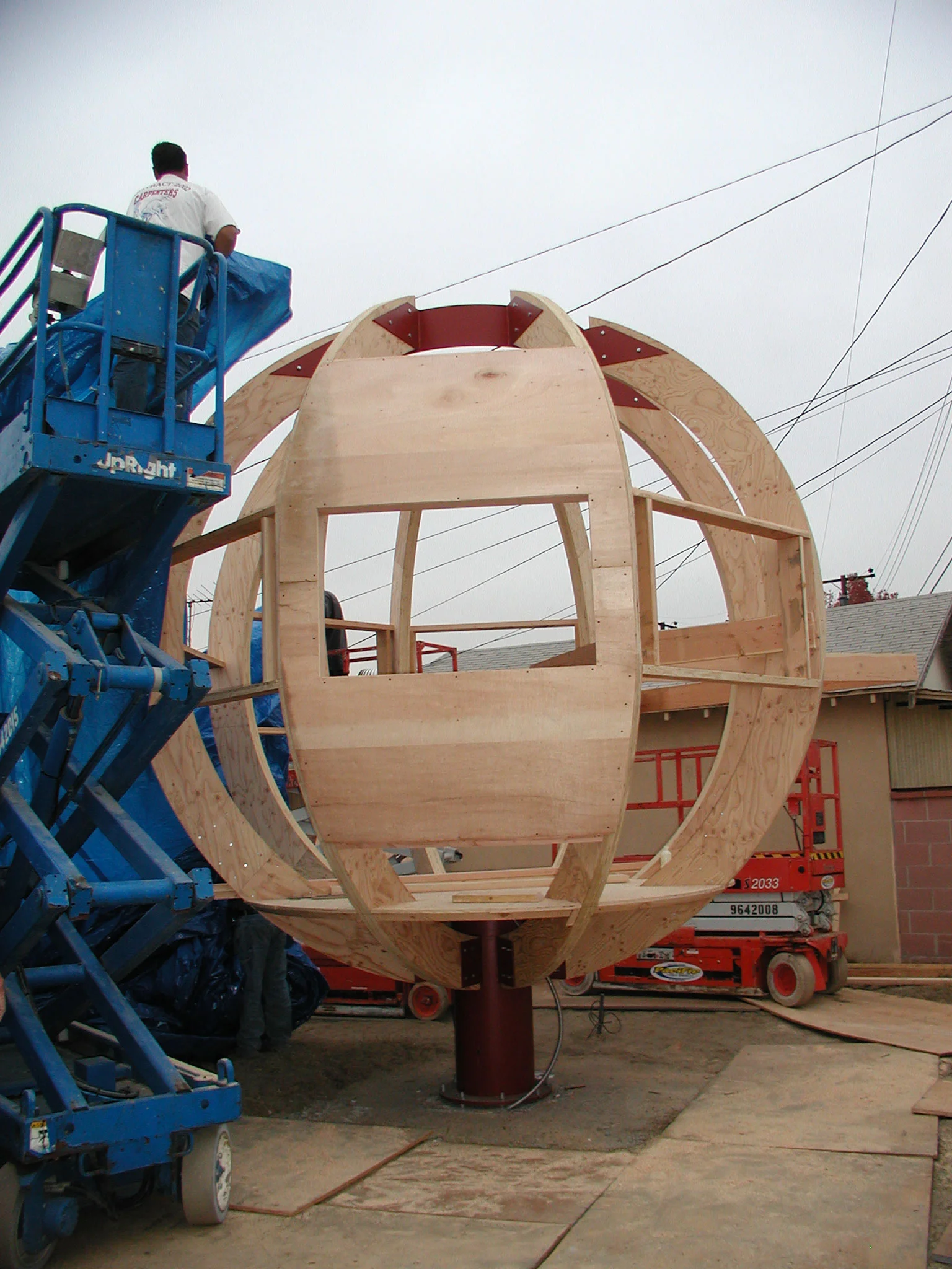 Plywood sheathing going over frame, in preparation for waterproofing and metal cladding.