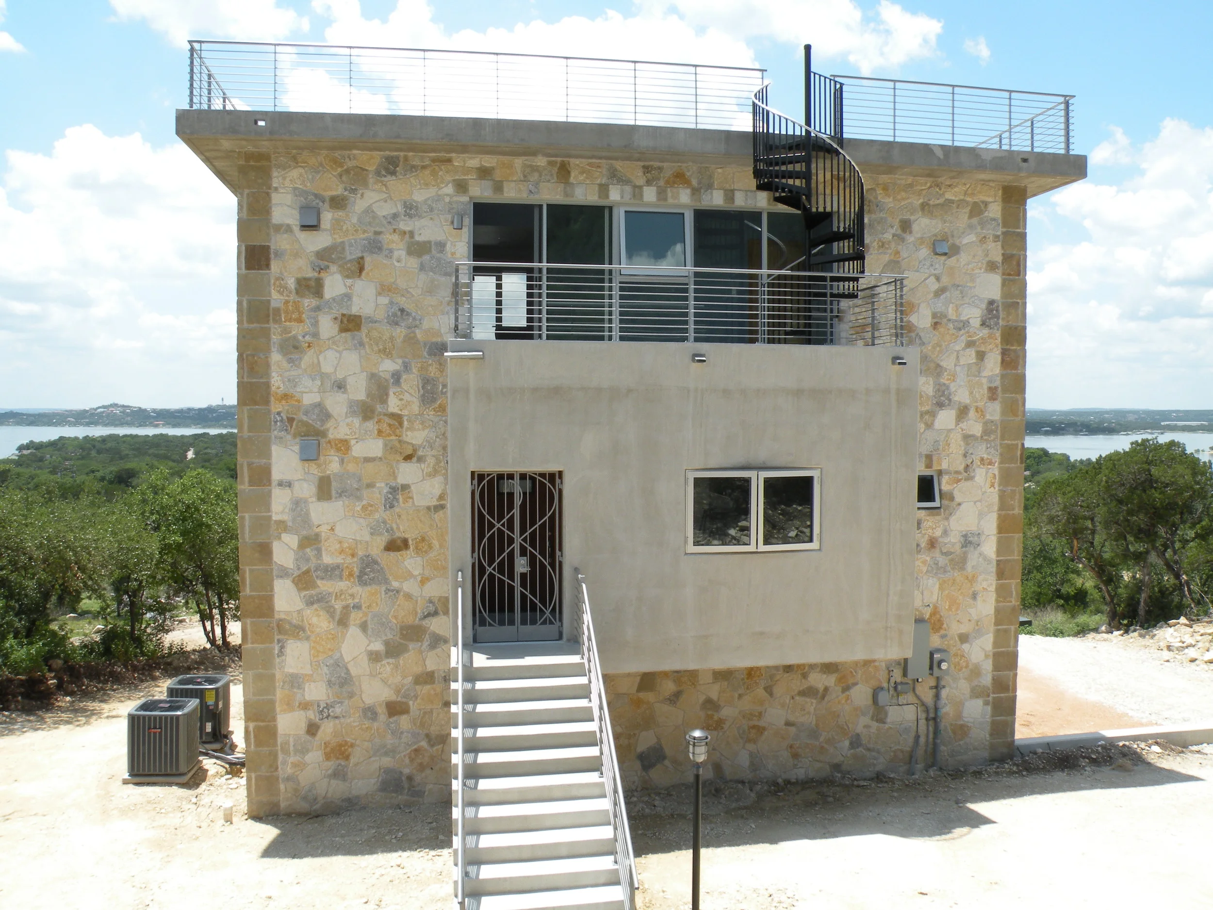 North face with formal entry with concrete stairs.