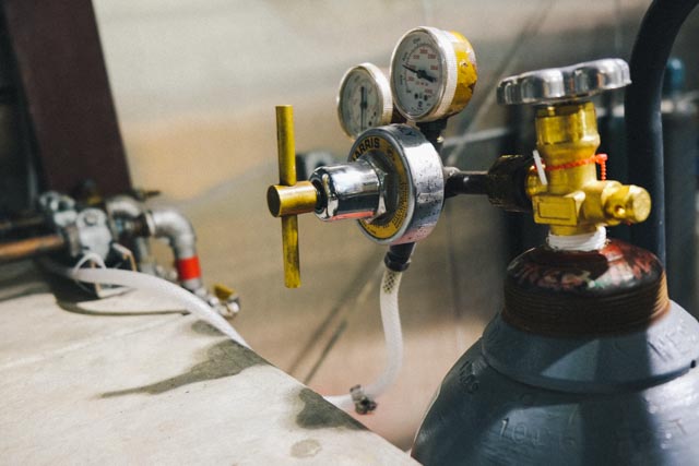 Gassing the headspace with CO2 to prevent oxidation of racked wine.