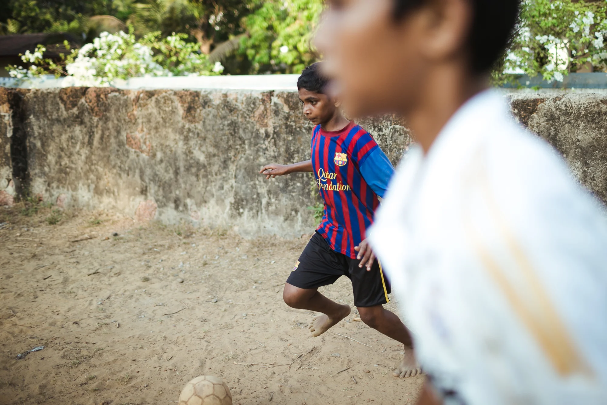 Kids playing football in Goa, India.