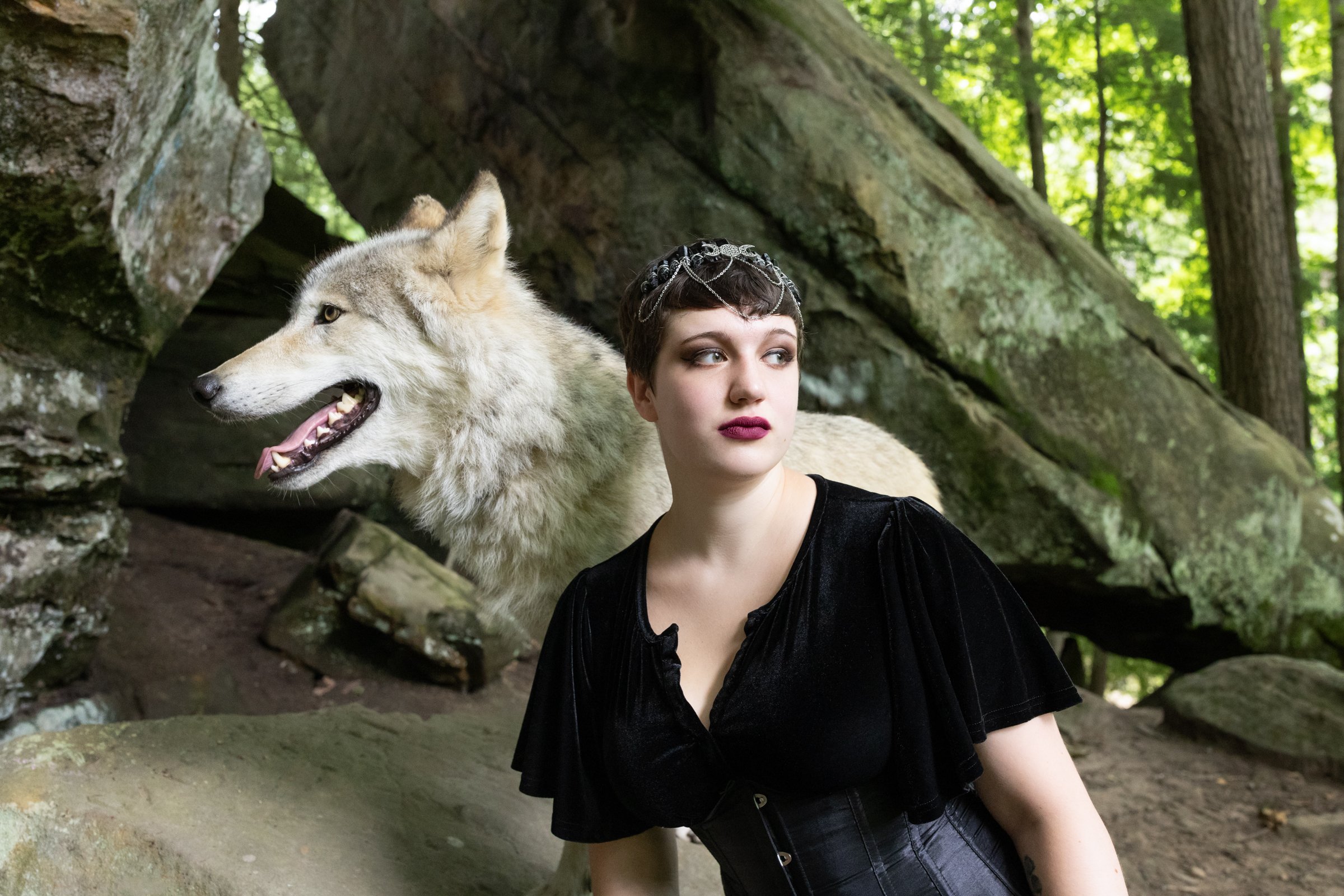 Senior photoshoot with a wolf | Michigan Photographer | Girl and wolf by cave
