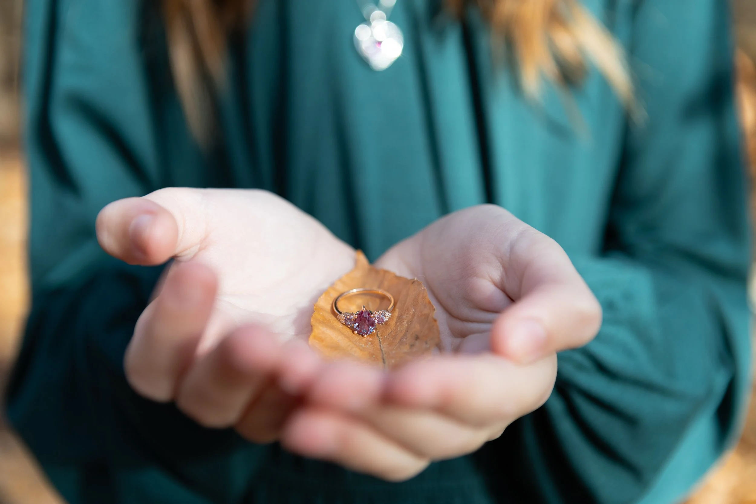 Engagement Ring on Fall Leaf in the daughter's hands